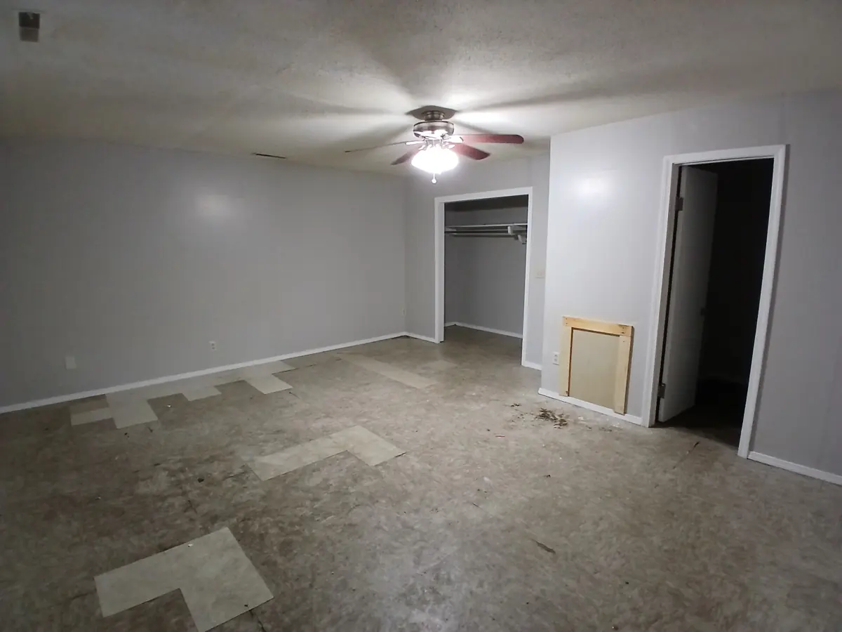 Patched floor to new plank — before